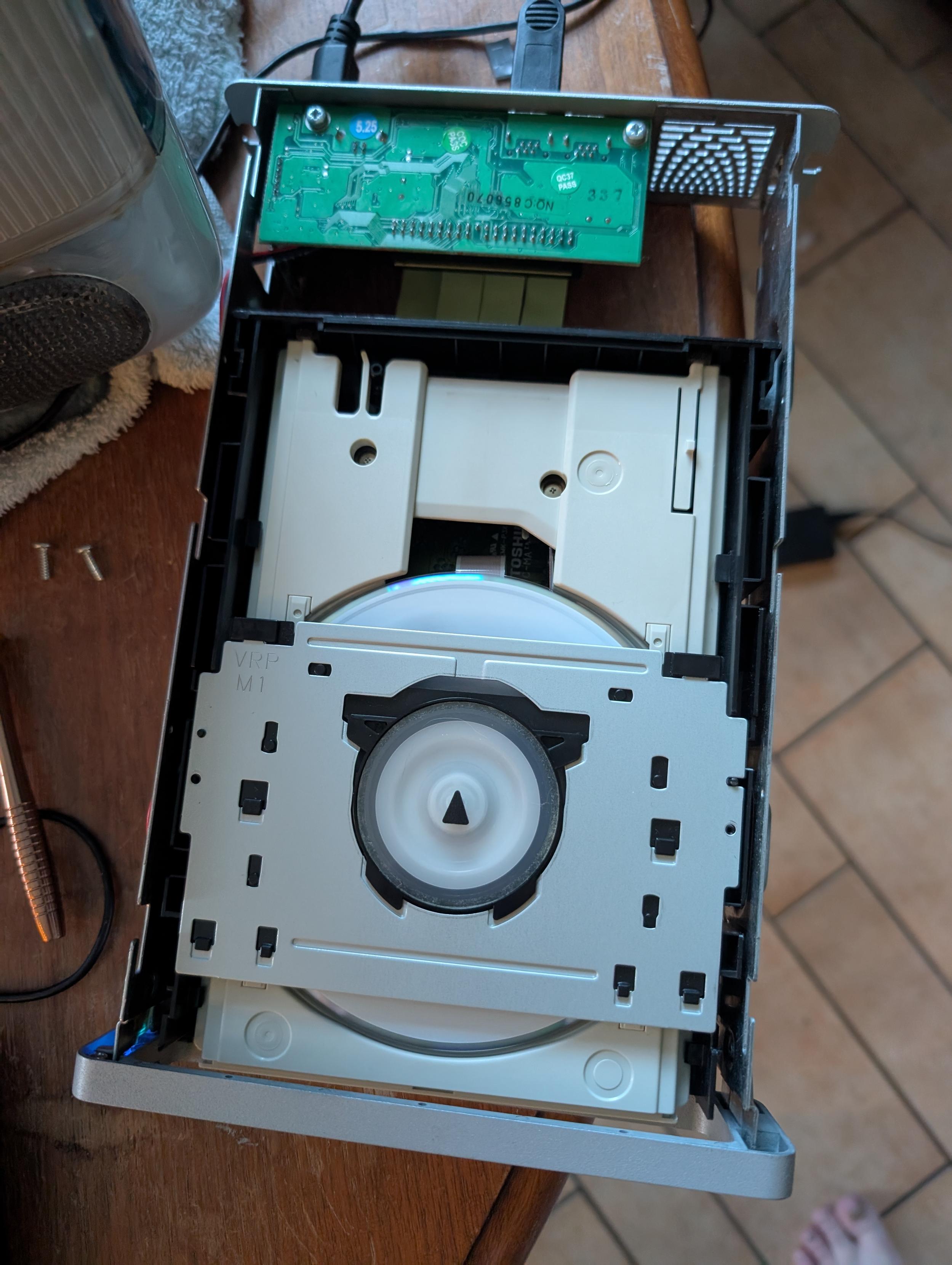 A picture of a partially disassembled dvd rom drive