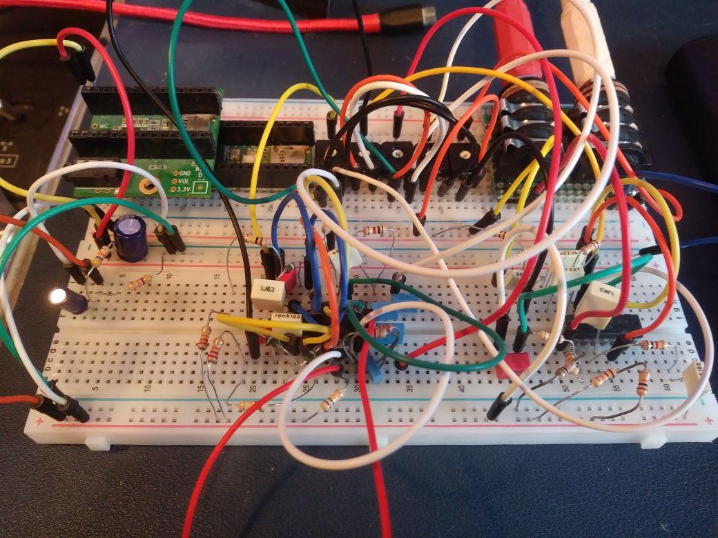 Messy looking breadboard based electronics prototype project with many wires and electronic components visible.