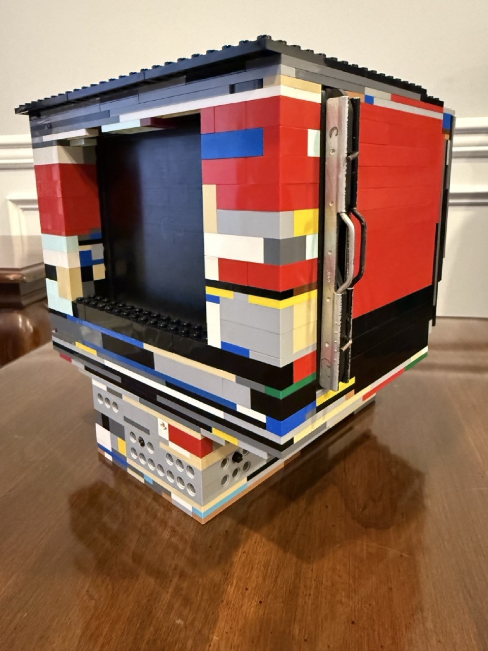 The back of a 4x5 film camera made of lego, showing the film carrier slot and rear viewing window.