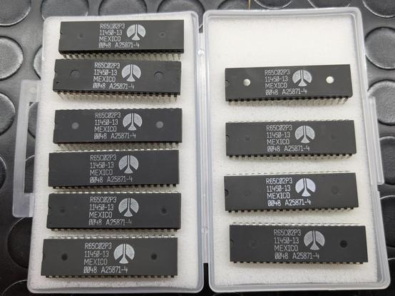 Photo of 10 ICs labeled as Rockwell 65C02 in a box. All of them shows signs of relabeling.