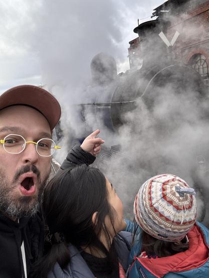 With my partner and our daughter at a railway museum somewhere in England, unintentionally recreating a meme