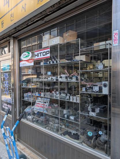 Shop window of a small store. Many different hydraulic components and valves are being displayed.