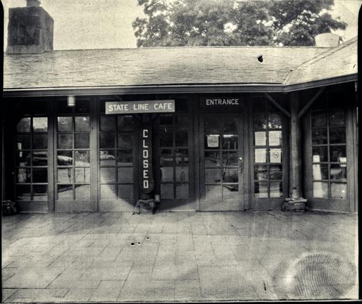 Black and white photo of the entrance to the state line cafe.