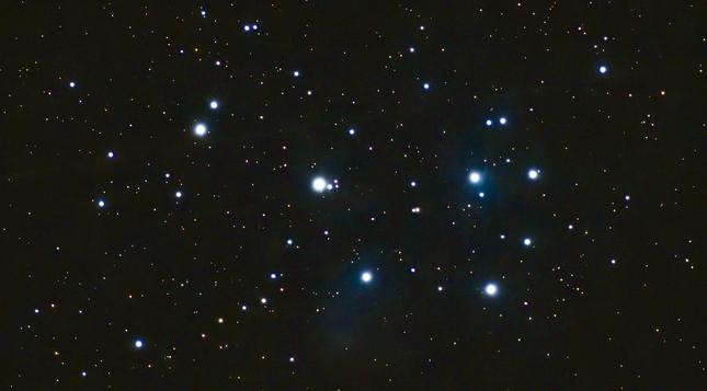 A dark shot with 7 points of light. It's a starfield, specifically, Pleiades, a star cluster 444ly from earth