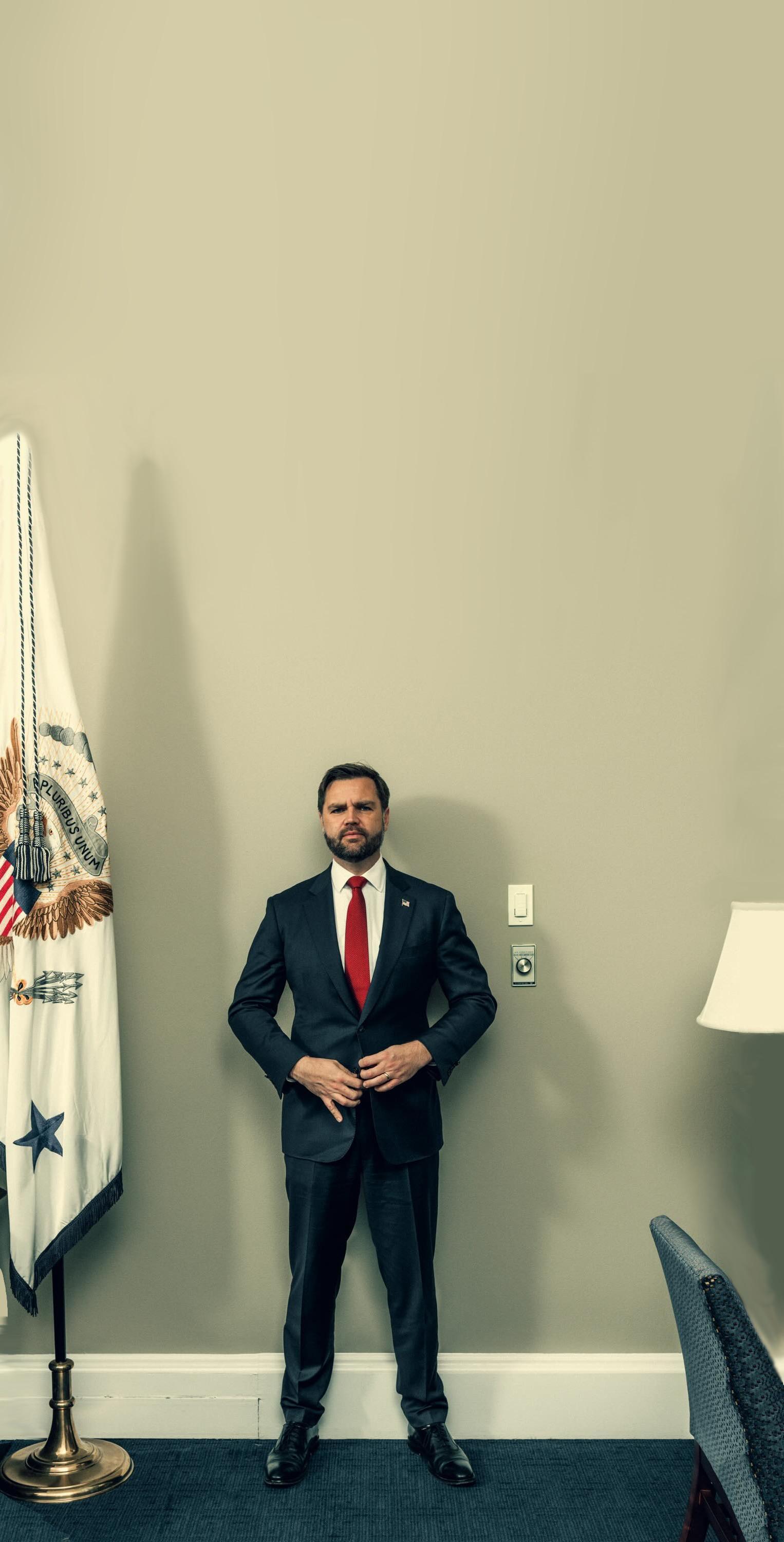 A photo of JD Vance against a wall. He appears very small.